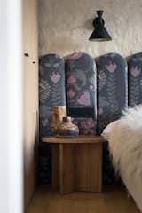 The bedroom offers rest and rejuvenation with double beds, designer headboards, wardrobes, an FDB Møbler bench, bedside tables, and decor from Ukrainian brands like GUSHKA and Basny Rugs, creating a cozy, tranquil retreat.