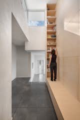 A covered exterior foyer leads to an internal corridor within the house, illuminated and connecting the different areas of the home
