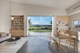 The house facing expansive green fields surrounded by mountain ridges