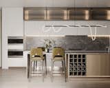 The kitchen design uses a variety of LED lighting elements, such as a decorative strip above the island, under-cabinet lighting and lights behind the glass fronts. This strategic lighting arrangement creates a subtle glow that gives the kitchen a radiant inner warmth.