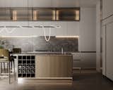The kitchen island boasts built-in cabinets with natural veneer fronts and an elegant wine cellar. This thoughtful addition enhances the island's design and functionality, making it a stylish and practical centerpiece.