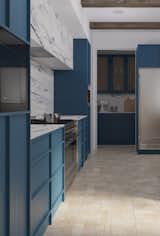 The kitchen cabinets seamlessly integrate with both built-in and freestanding appliances, creating a sleek, uninterrupted line. Clever storage solutions conceal all utensils from view, while dedicated appliance garage space and additional cabinets offer ample storage, preserving the clean, minimalist aesthetic of the kitchen.