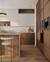 This Japandi kitchen showcases linear-framed cabinets in American walnut veneer, perfectly complemented by white upper cabinets. Together, they create a sense of balance and understated sophistication within the clean, minimalist layout.