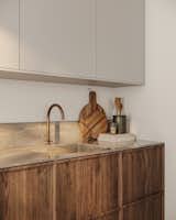 The cabinets and walls share the same soft white tone, creating a cohesive look that enhances the sense of harmony and tranquility throughout the kitchen.