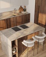 The kitchen island, topped with sleek Dekton countertops, includes a built-in cooktop that showcases the perfect fusion of practical functionality and sophisticated design.