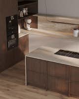 Designed with simplicity and function in mind, the kitchen island pairs warm wood cabinetry with a built-in cooktop and a robust Dekton surface, creating a harmonious and grounded focal point in the minimalist space.