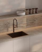 The Dekton countertop and backsplash showcase a stone-like grain that complements the organic aesthetic of Japandi design, while their durability and low maintenance make them a practical, long-lasting choice for everyday use.