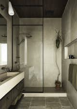 The original main bathrooms had been fitted with drop ceilings and builder-grade trim and tiles, which were not up to the client's expectations. Our team collaborated with local artisans to craft a modern aesthetic while adding antique finishes, vintage materials, and high-quality products. We imported plumbing fixtures from our motherland, Australia, and had the vanities custom-made by local craftsmen. The custom sinks were created by local concrete artisans, resulting in a modern take on a Moore House Designed bathroom.