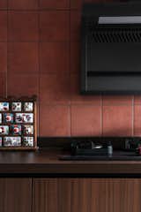 Terracotta tiles in the kitchen match the overall terracotta texture of the house, binding 
the entire space together in a cohesive design
 