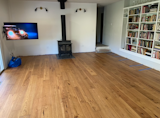 During: removed carpet, demo'd wall of rocks plus hearth and gained 5' of floor from the fireplace. Understated and classic for a mcm/ranch house