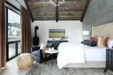 The Rustic Modern primary bedroom features a natural material palette.