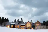 The exterior features Kebony wood and Montana Moss rock.