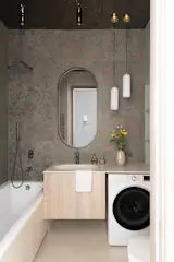 The master bathroom, another standout feature, incorporates custom Spanish tiles featuring hand-
painted golden branches, a tribute to craftsmanship and artisanal skill. The intricate design on these
tiles brings the beauty of nature indoors, creating a luxurious yet serene environment for daily
rituals. A ceiling with a water ripple effect in a deep graphite shade not only adds elegance but also
plays with the light, creating a unique visual effect that enhances the space’s ambiance.