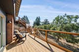 New deck overlooks a large backyard and an additional parcel included in the sale