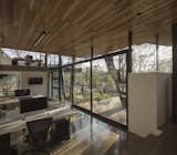 Natural light floods the space, a result of the design of a building with abundant glass surfaces, allowing for maximum utilization of natural light and enhancing the architectural details