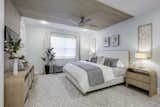 Primary Bedroom with different textured wood and a wool and hide woven rug.