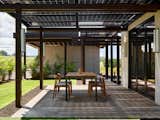 The design makes innovative use of materials to maximize energy generation and efficiency. The bifacial glass solar panel array serves dual purposes, generating power from both direct sunlight and reflected light from the concrete below.