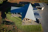 The roof has a parabolic curve that is derived from rotating the ridge beam to respond to the sun's path while allowing the rest of the dwelling to align with the view and prevailing winds.