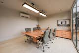 Spaces designed to work with you — this conference room features acoustic walls, sleek metal furniture, customized lighting, a floating table for visual lightness, and portable solutions crafted from thoughtful material choices.