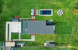 This aerial perspective highlights the thoughtful design of Cabaña Serena, a retreat that combines modern aesthetics with eco-conscious living. The property features essential amenities such as a full backup generator, potable water cisterns, and ample parking. The inviting saltwater pool, surrounded by carefully curated greenery, adds a touch of luxury, while the open layout reflects the property’s harmony with nature and commitment to sustainability.