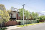 350 sq metres of living space on a 480 sq metre block, the triple-storey box-like structure with wooden panels is set within an exposed steel structural exoskeleton with a roof deck.
