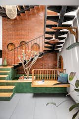 A striking first flight of stairs, elegantly finished in green oxide, extending into the adjoining waterbody and seat, creating a sculptural interplay of form and function.