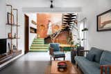 A well-connected living, dining, and courtyard space occupies half the site, featuring earthy materials, greenery, and custom crafted elements.