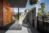 The porch is designed with a sense of semi-privacy with delicate terracotta jali blocks and matching square-cut patterns in the gate, inviting the breeze while gently veiling it from prying eyes.