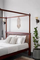 A graceful four-poster bed sits elegantly within the double-height space, exuding quiet luxury without overwhelming the room.