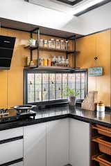 A charming corner window in the kitchen offers a direct view of the porch, bringing in natural light and a visual connection to the outdoors.