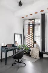 The future children’s bedroom, currently used as a workspace, features a beautiful fixed seat by the jaali, offering both privacy and soft natural light from the balcony.
