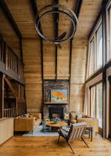 Newly installed douglass fir boards are the background for the original fireplace and stairs in the living room's double height space