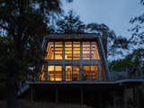The A-frame house starts glowing at dusk