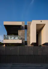 A transparent corner composition blending glass and steel, merging interior and landscape through seamless thresholds.