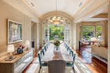 A Masterclass in Architectural Elegance: Timeless Details in a Refined Dining Space
Nestled within a home that epitomizes timeless elegance, this dining room is a showcase of sophisticated architectural details. Every design element, from its soaring vaulted ceiling to its intricate wall paneling, contributes to an ambiance of understated luxury.
A Ceiling That Elevates the Space
The vaulted ceiling serves as the room’s architectural centerpiece, subtly curving to add height and grandeur. Accentuated by crown molding and recessed lighting, it achieves a perfect balance of classic formality and contemporary airiness. Indirect cove lighting further enhances the effect, casting a soft glow that highlights the room’s refined features.
Walls That Tell a Story
Applied molding in a picture-frame style gives the walls depth and structure, echoing the timeless craftsmanship of European estates. Below, elegant wainscoting reinforces the room’s sense of scale, while thick door and window casings frame the space with architectural integrity.
Doors and Windows as Architectural Statements
A set of arched French doors, flanked by transom windows, creates a seamless transition between the dining room and the lush garden beyond. These divided-light windows and doors introduce an abundance of natural light, establishing an effortless indoor-outdoor connection. Meanwhile, an adjoining bay window alcove offers a quiet retreat, perfectly integrated into the larger space.
A Foundation of Warmth and Contrast
Beneath it all, rich hardwood flooring grounds the space, adding warmth that contrasts beautifully with the creamy wall paneling. Wide baseboards provide a finishing touch, ensuring that every transition—from floor to wall to ceiling—is impeccably executed.
Furnishings That Complement the Architecture
A grand chandelier, centered over the dining table, echoes the elegance of the ceiling’s gentle curve. Upholstered dining chairs in a muted blue-green introduce a soft contrast, while a mirrored console reflects both natural light and architectural beauty.
A Harmonious Integration with Nature
Through the expansive French doors, the structured symmetry of the garden mirrors the dining room’s own meticulous proportions. This interplay between interior and exterior, formality and comfort, solidifies the space as a true masterclass in architectural harmony.
With every molding, every pane of glass, and every carefully chosen material, this dining room demonstrates the enduring power of thoughtful design. It is a testament to the idea that true elegance is not merely aesthetic—it is architectural.
