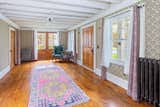 fully exposed joists, high ceilings, vintage wallpaper and a mind blowing color palette add to the character to the house
