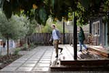 A sleek black trellis with willow panels covering a deck off the back of the home. 