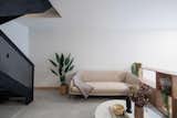 The mezzanine hosts a sleek and well-organized living room.
