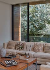 A fresh and cozy ambience is achieved through the use of furniture and neutral tones.