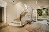 Entry way. We love the existing curves in the steps, so we maintained the shape, installed new engineered oak flooring throughout and added honed marble on the first two steps. 