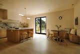 Kitchen features a curved island, plaster walls and hood covering with a built in breakfast nook that mimics the same curve detail. The kitchen doors lead to the backyard and built in outdoor bbq. The countertop and backsplash may be our favorite stone in the house. It's a honed marble we were fortunate to find at Bedrosians. 
