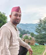 Native Kumaoni Chandan Singh Koranga- Proud Owner of Koranga's Wood Villas in traditional Kumaoni attire.
