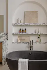 Her Primary Bath with Concrete Soaking Tub