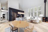 The interior blends Scandinavian and modern rustic styles, with light wood flooring, white walls, and dark wood accents.
