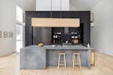 The kitchen is a prime example of function and style featuring Reform oak cabinetry, integrated appliances, and an expansive quartz island.