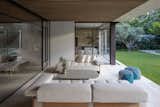 A beautifully designed outdoor living space with plush seating, a cozy ambiance, and seamless integration with nature.
