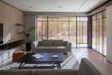 The neutral-toned furniture, wood accents, and natural light create a serene and inviting atmosphere, perfect for relaxation or entertaining.