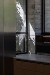 This close-up captures the interplay of light and texture beautifully.The mix of materials—stainless steel, wood, and marble—gives the area a refined yet natural feel.