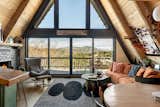 Our open-concept kitchen, dining, and living area offers seamless flow, perfect for gathering. Cook with ease in the fully stocked kitchen, while enjoying the wood-burning fireplace and scenic views. 