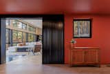 The corrugated metal skin of the new volume continues inside the home.